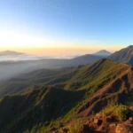 Majestic Mount Rinjani with volcanic crater and lush greenery, captured during sunrise, showcasing its natural beauty and rugged terrain for adventure seekers.